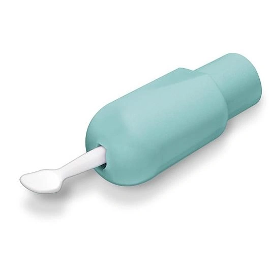 Una herramienta médica verde claro con un extremo blanco en forma de cuchara.